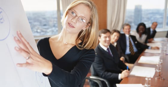 Woman presenting before board members