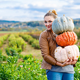 Woman carrying pumpkins