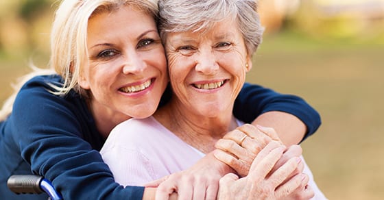 Woman hugging elderly parent