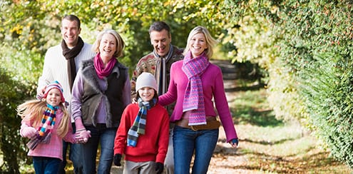 family walking down a lane happy