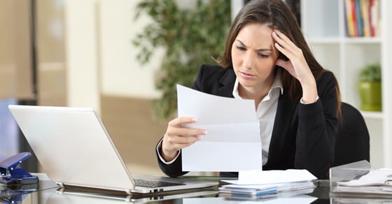 Woman reading letter confused