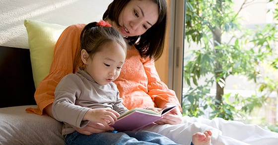 Mother reading to daughter