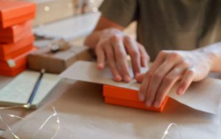 woman wrapping holiday gifts