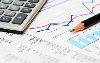 calculator, business financials and growth chart